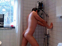 beautiful young man takes douche