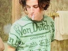 Skinny twink smokes in the bathtub and strokes his cock