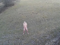 Guy is masturbating naked in open area