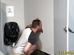 Tattooed hunk sucked through gloryhole