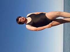 At the beach in swimsuit