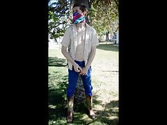 Pissing in the neighborhood with cars driving by outdoors