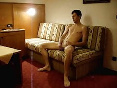 Naked twink strokes his cock in a hotel room