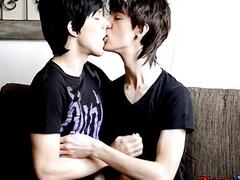 Two young men with long hair jerking each other off hard