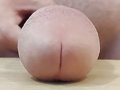 Slapping huge cock on table in slow motion