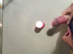 Homemade handjob and big load on a candle. Jerking off in a homemade amateur video, big cock and big load.