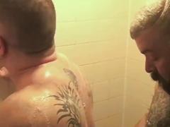 Two large gay bears have anal sex in the shower