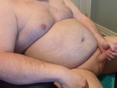 Chubby father strokes his rock hard cock
