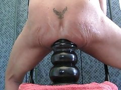 A giant black dildo in the ass