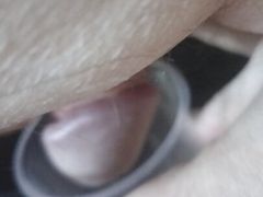 Jerking dick for cum in plastic cup.