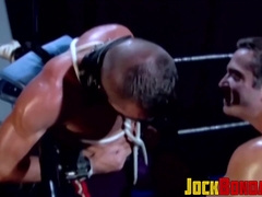 Tattooed wrestler tied up and dominated by his opponent