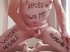 Lars Hviid on his knees showing his degrading bodywriting