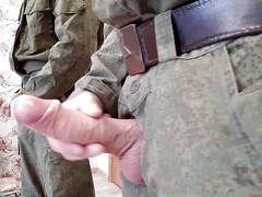 A Russian soldier in military uniform and dirty socks jerks off his dick
