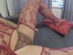 Feminine bottom indulges in anal masturbation wearing red fishnet stockings