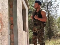 Muscular bearded soldier strips binds and gags young man.