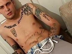 Tattooed thug pulls his cock out to jerk off solo