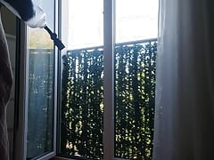 In Lingerie at the Window Passing Neighbors