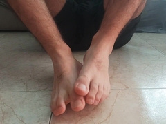 Nasty fellow rubbing his soles. Sole fetish