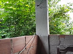 Masturbating on the balcony.