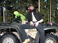 Biker pissing in the public campground for fun on cold sunny day.