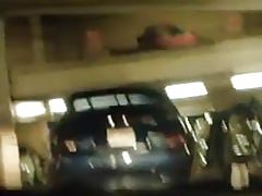 A wanker in a parking garage