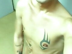 Tattooed twink jerks off with masturbator at public locker room