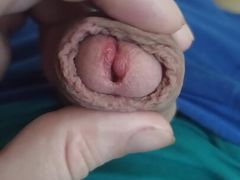 The guy shows his penis head in close-up, jerks off his penis