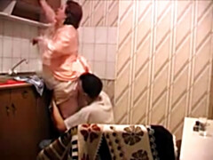 Son drills mother at the kitchen