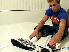 Cute lad touches his astounding feet and tugs his dick solo