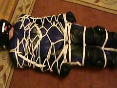 Tied biker in the one-piece leather bikersuit