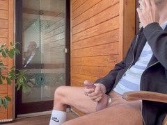Horny stud smokes on the balcony while jerking off his big cock