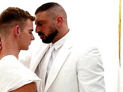 A man in a suit is banging the hell out of a petite lad