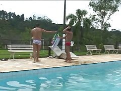 Latino gay couple make out by the swimming pool