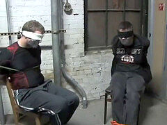 BG Two young detectives bound to stools ball-gagged and eyes covered.