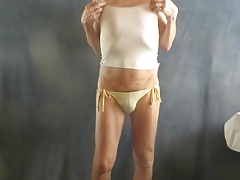 Panty sissy models his string bikini.