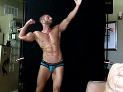 Muscular bodybuilder Zack Daniels plays with his penis