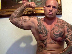 Tattoed muscled guy works out his dick in front of the cam