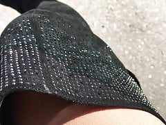 Crossdresser posing outdoor in the sun with shiny nylons