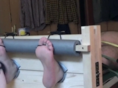 Naked bear tickled in stocks and on a rack