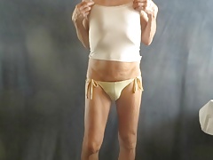 Panty sissy models his string bikini.