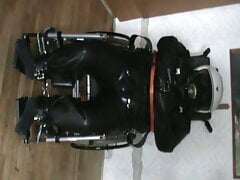 Straitjacketed slave in the wheelchair