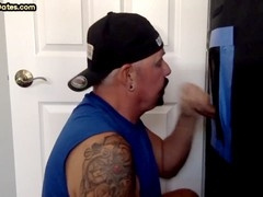 Inked daddy at gloryhole swallows four cumshots in amateur deep throat video